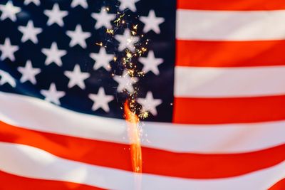Full frame shot of american flag with sparkler
