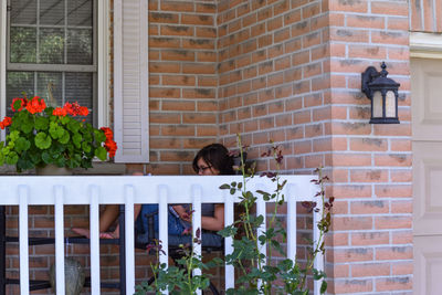 Side view of mid adult woman sitting in balcony