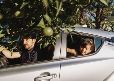 Portrait of girl looking at the road through the car window