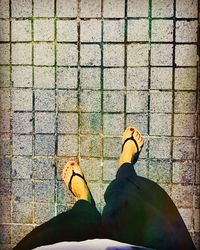 Low section of woman standing on tiled floor