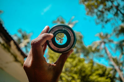 Midsection of person holding camera