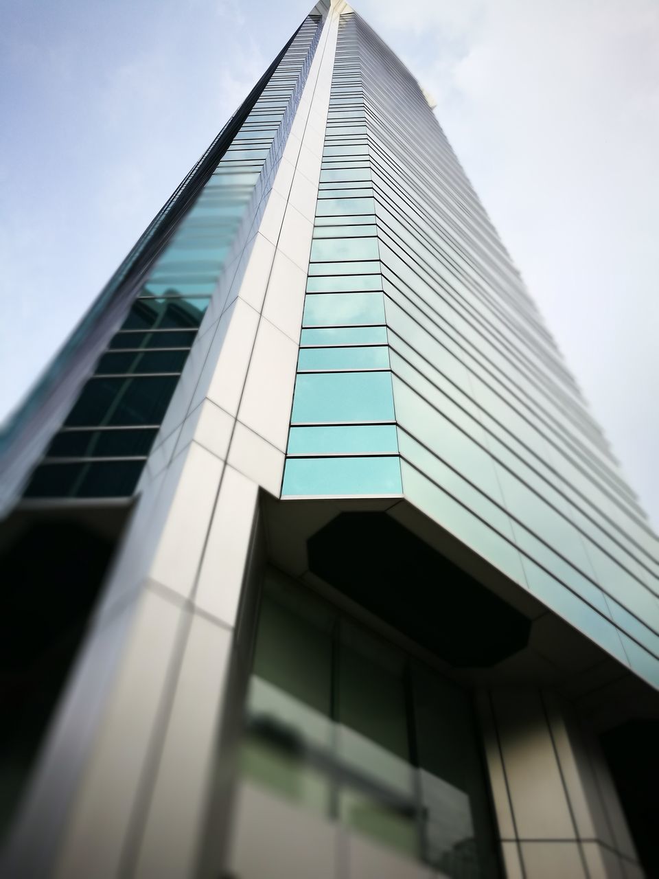 architecture, building exterior, built structure, low angle view, skyscraper, tower, office building, modern, tall, tall - high, city, glass - material, sky, reflection, building, cloud, glass, day, building story, diminishing perspective, development, place of work, office block, no people