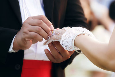 Midsection of couple holding hands