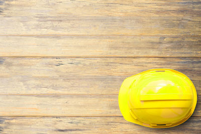 High angle view of yellow glass on table