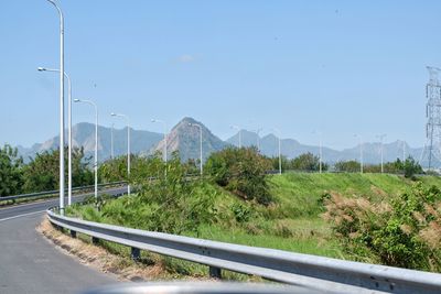 Road by plants against sky