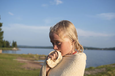 Girl wrapped in towel at lake, siljan, dalarna, sweden