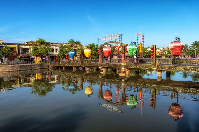 An hoi bridge and an hoi town reflection on the thu bon river in hoi an, vietnam