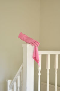 Pink latex glove on stair railing 