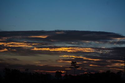 Low angle view of silhouette trees against sky at sunset