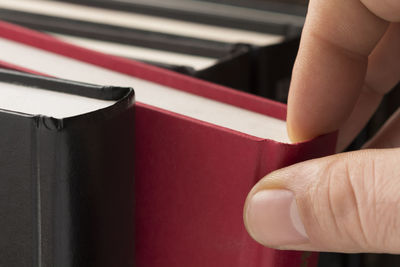 Cropped image of hand holding book