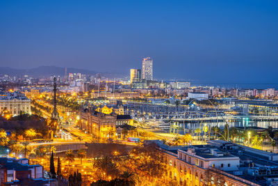 View of barcelona with the columbus statue from montjuic mountain at night