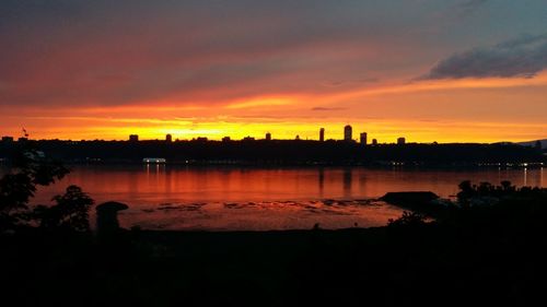 Scenic view of lake against orange sky