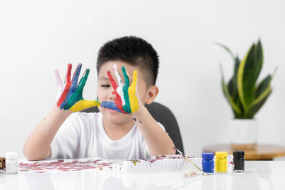 Portrait of boy holding colorful table