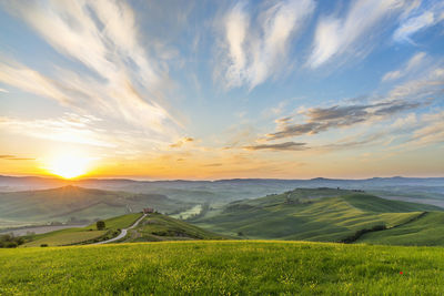 Scenic view of field against sky during sunset