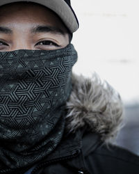 Close-up portrait of young man covering face