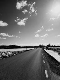 Road amidst landscape against sky