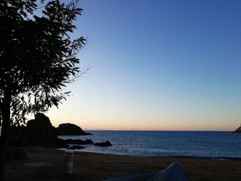 Scenic view of sea against clear sky at sunset