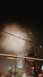 Low angle view of firework display against sky at night