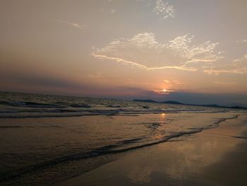 Scenic view of beach against sky during sunset