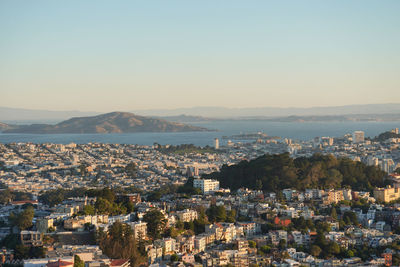 High angle view of townscape by sea against sky