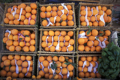 Directly above shot of oranges in boxes for sale in market