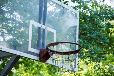 Low angle view of basketball hoop against trees