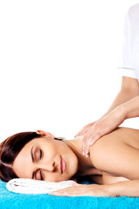 Portrait of woman lying down against white background
