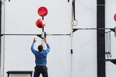 Sportsman exercising with medicine ball in gym