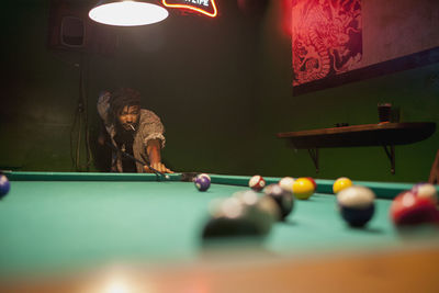 A young man playing pool.