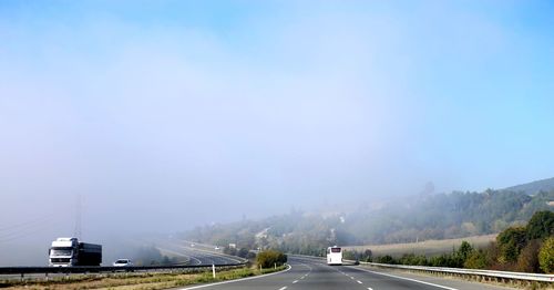 Cars on road against sky