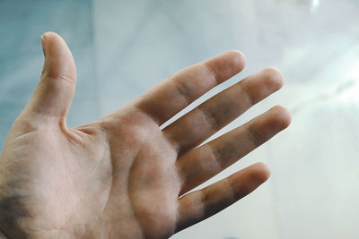 Cropped hand of man over floor