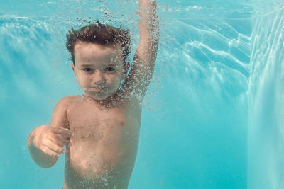 Boy swimming in pool