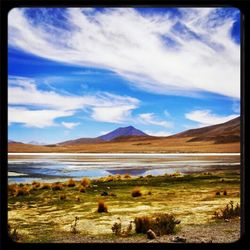 Scenic view of mountains against cloudy sky