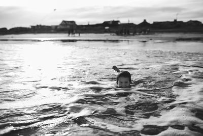 Duck swimming in water against sky