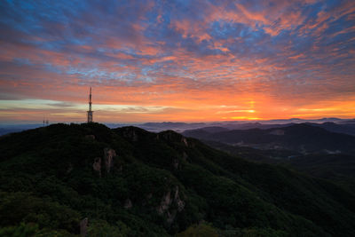 Scenic view of mountains against orange sky