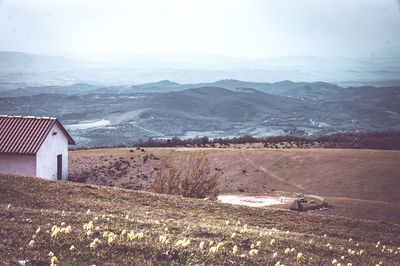 Scenic view of landscape and mountains against sky