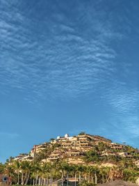 Low angle view of buildings against blue sky