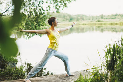 Young smiling woman practice yoga outdoors. new normal social distance. physical and mental health
