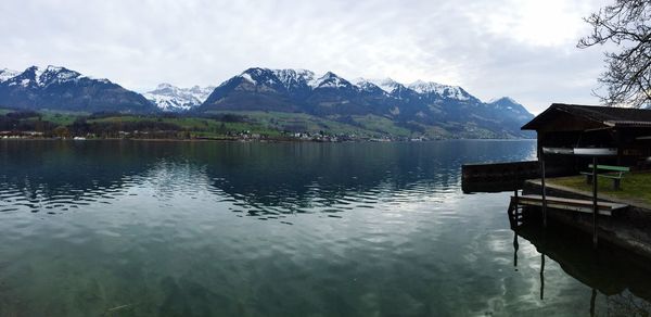 Scenic view of lake and mountains against sky