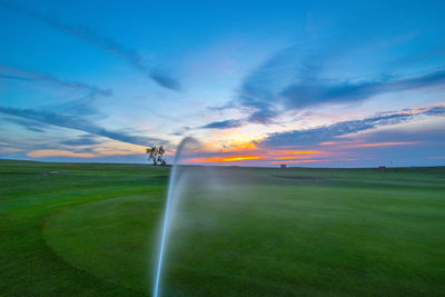 Scenic view of land against sky during sunset