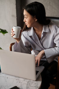 Young woman using laptop at home