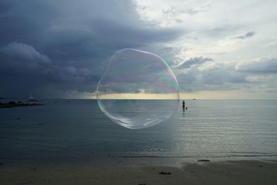 Scenic view of sea against cloudy sky