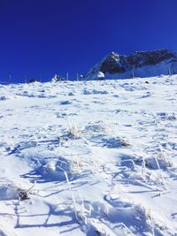 Scenic view of snow covered mountains against clear sky