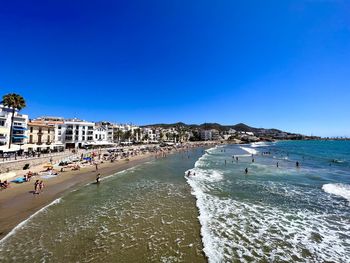 Panoramic view of beach against clear blue sky