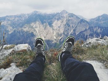 Low section of man standing on mountain