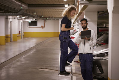 Man and woman checking air duct