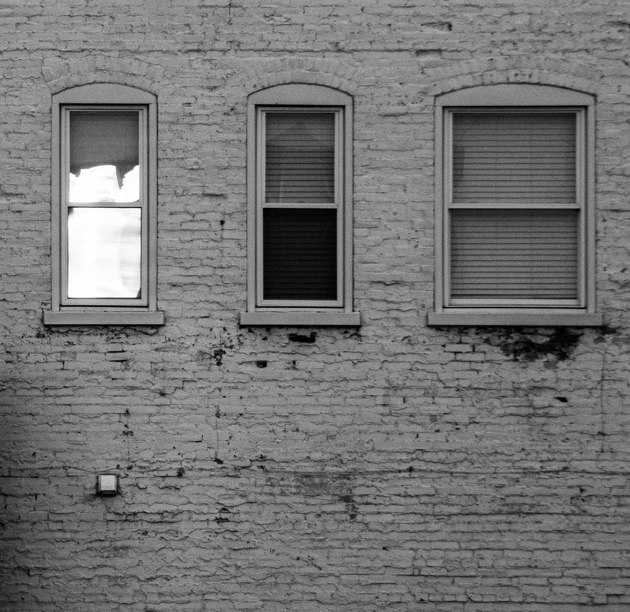 LOW ANGLE VIEW OF WINDOW ON WALL OF OLD BUILDING