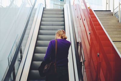 Man standing on escalator