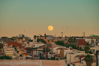 Townscape against sky during sunset