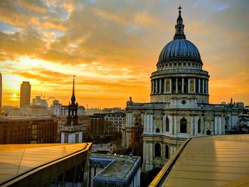 View of buildings in city during sunset